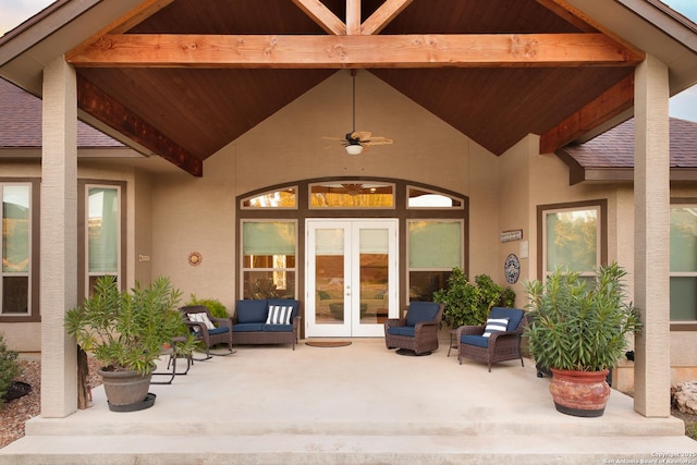 view of exterior entry with french doors, a patio area, ceiling fan, and an outdoor living space