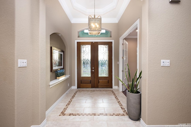 entryway featuring ornamental molding and french doors