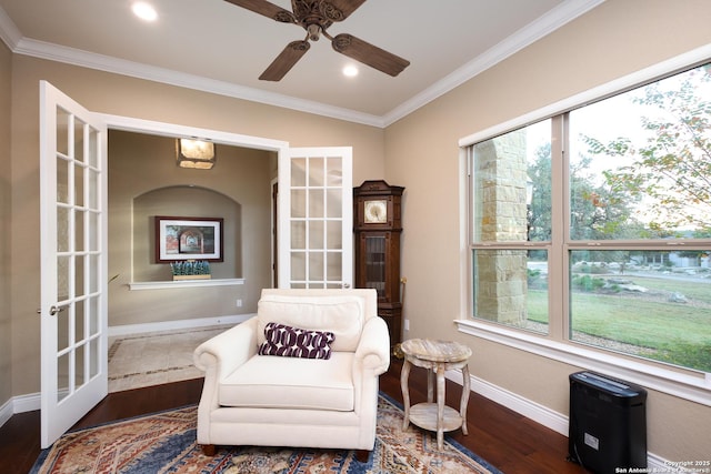 living area featuring french doors, ornamental molding, ceiling fan, and dark hardwood / wood-style floors