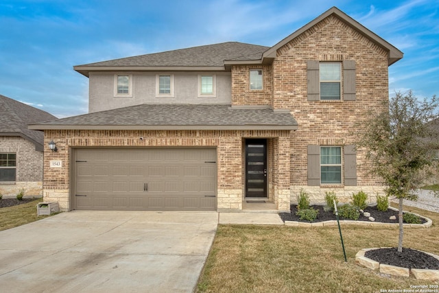 view of front of house with a garage and a front lawn