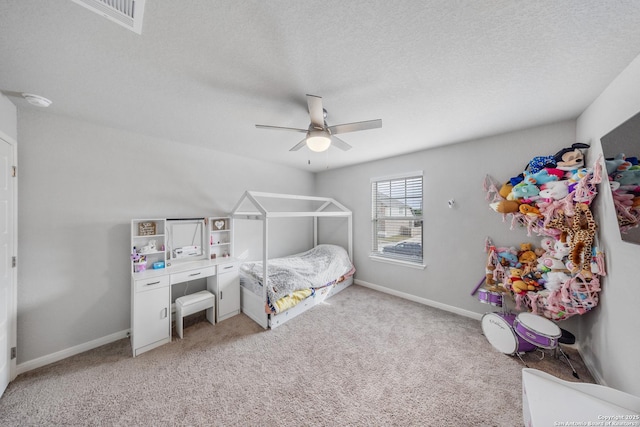 bedroom featuring ceiling fan, light carpet, and a textured ceiling