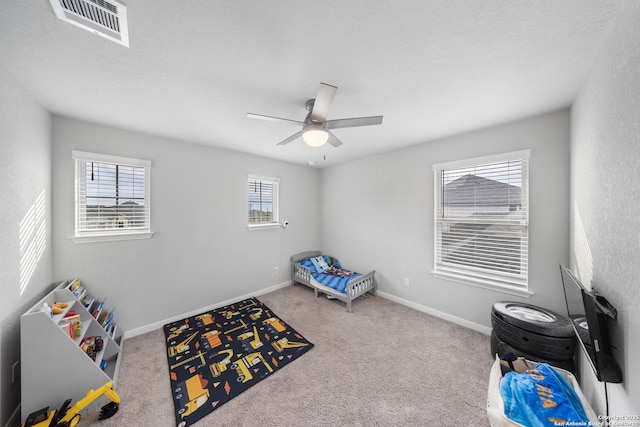 rec room with ceiling fan and light colored carpet