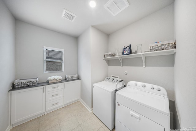 laundry room featuring light tile patterned flooring and separate washer and dryer