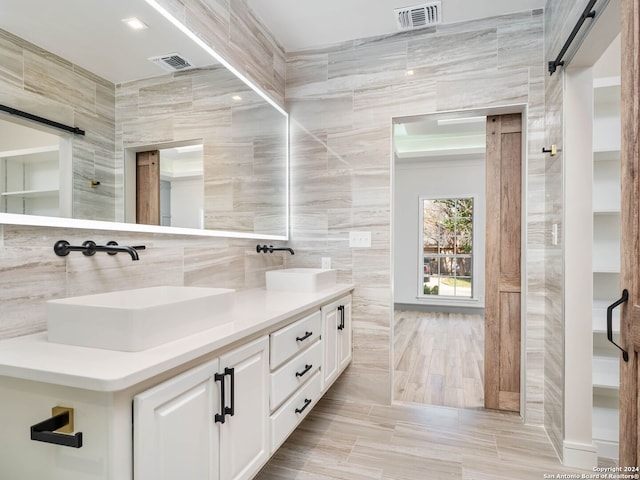 bathroom with tile walls and vanity