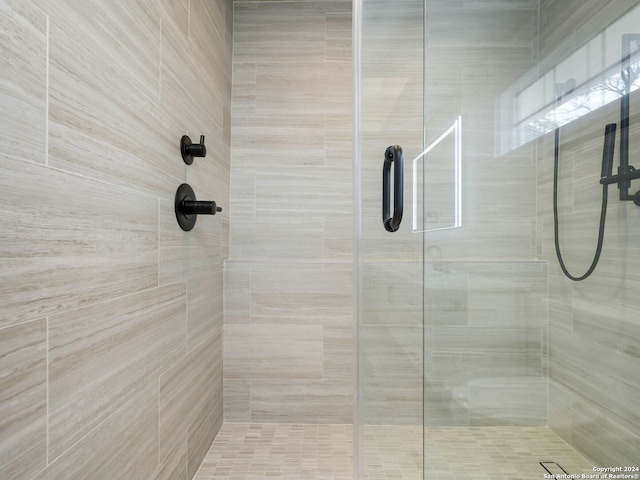 bathroom with a shower with door