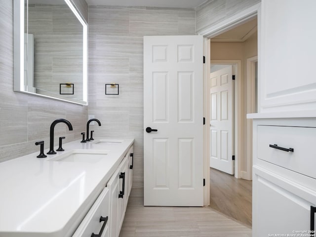 bathroom featuring tile walls, tasteful backsplash, and vanity