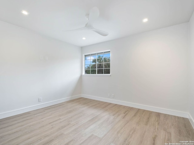 empty room featuring ceiling fan and light hardwood / wood-style floors