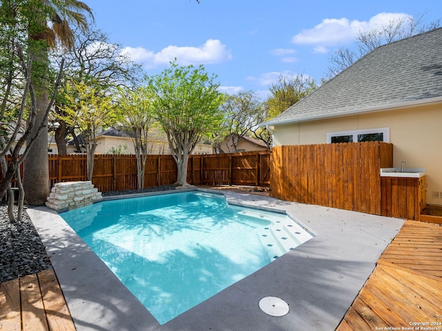 view of pool with a wooden deck