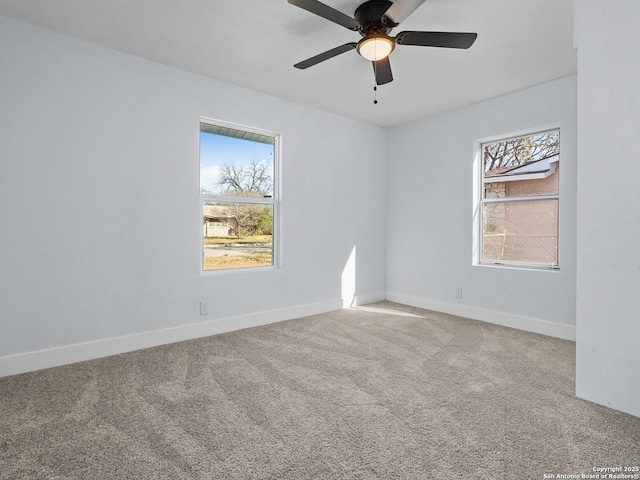 spare room with ceiling fan and carpet