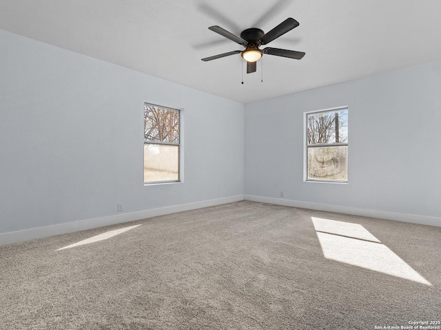 carpeted spare room with ceiling fan