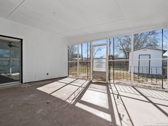 unfurnished sunroom featuring ceiling fan