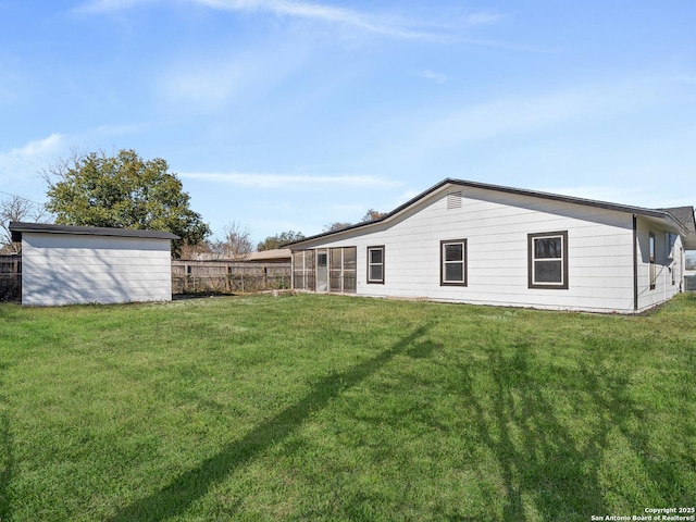 rear view of house featuring a yard