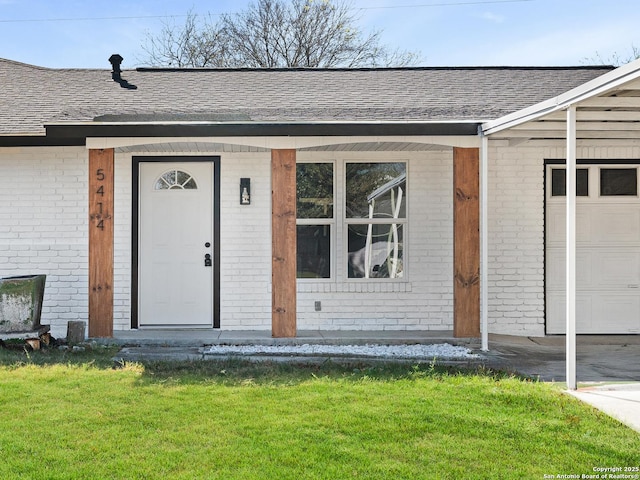 view of exterior entry featuring a yard