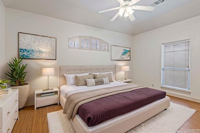 bedroom with ceiling fan and light wood-type flooring