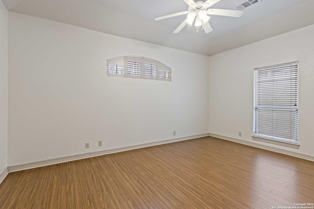 unfurnished room with ceiling fan and hardwood / wood-style flooring