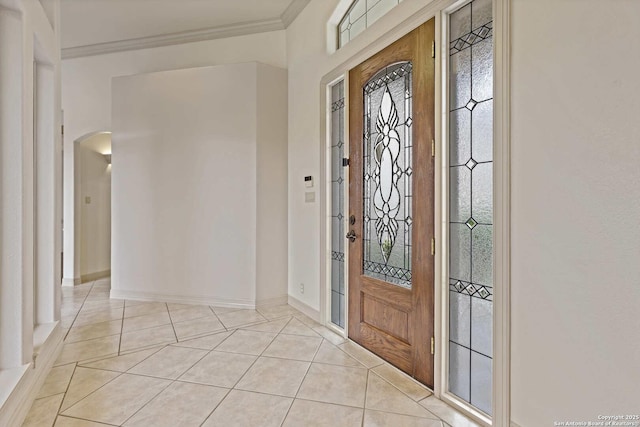 foyer featuring ornamental molding and light tile patterned floors