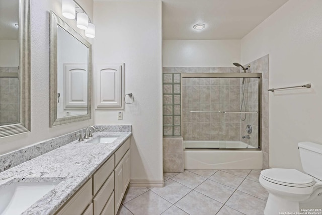 full bathroom with toilet, bath / shower combo with glass door, tile patterned floors, and vanity