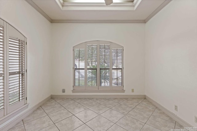 tiled spare room with a raised ceiling and crown molding