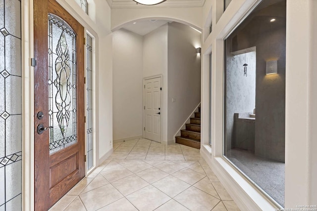 foyer entrance with light tile patterned floors and plenty of natural light