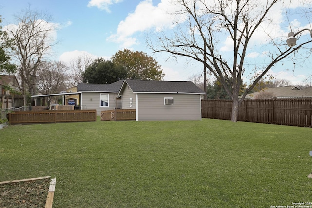 rear view of property featuring a deck and a lawn