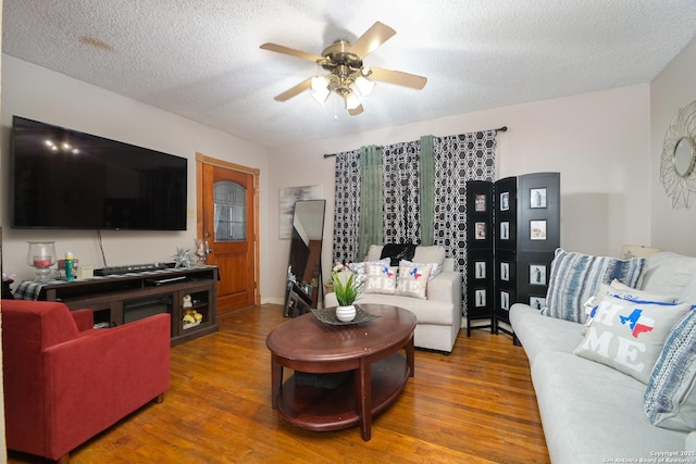 living room featuring a textured ceiling, ceiling fan, and wood-type flooring