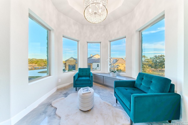 sitting room featuring a chandelier and a wealth of natural light