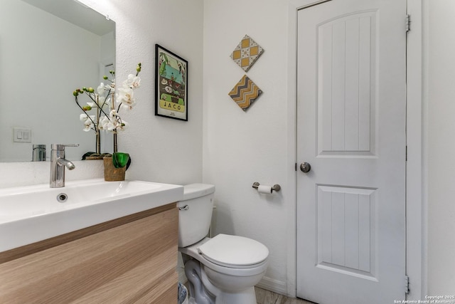 bathroom with toilet and vanity