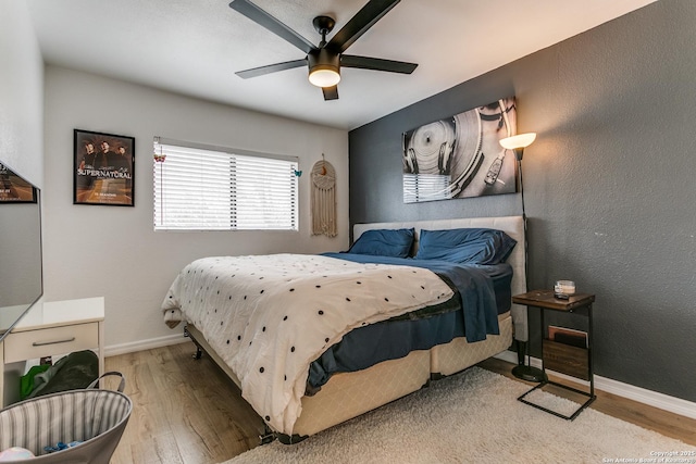 bedroom with ceiling fan and light hardwood / wood-style floors