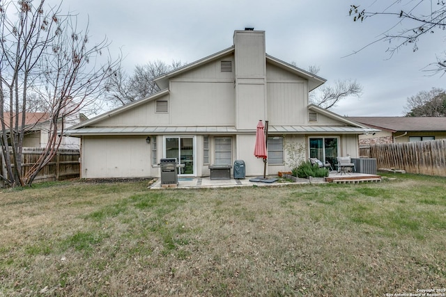 back of house with central AC unit, a patio, a wooden deck, and a lawn