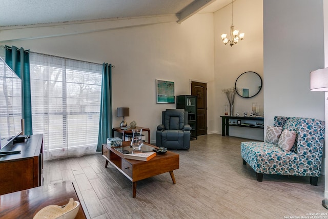 living room featuring wood-type flooring, a chandelier, and vaulted ceiling with beams