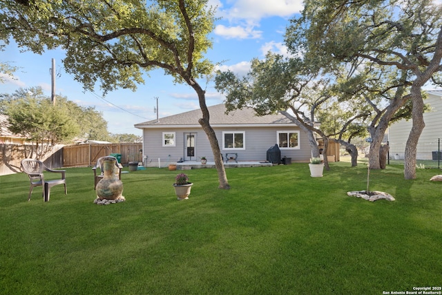 rear view of house with a yard