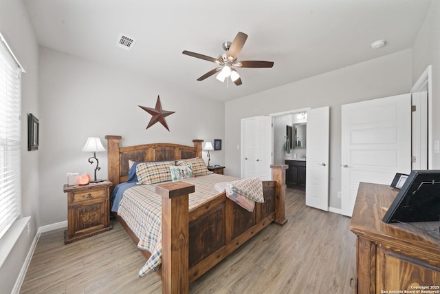 bedroom with ceiling fan, light hardwood / wood-style flooring, and connected bathroom