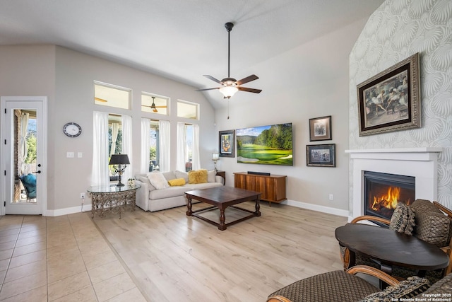 living room with vaulted ceiling, ceiling fan, and light hardwood / wood-style floors