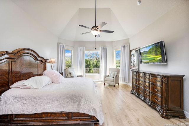 bedroom featuring high vaulted ceiling, ceiling fan, and light hardwood / wood-style floors