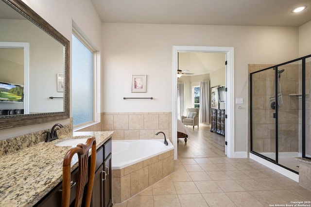 bathroom with ceiling fan, separate shower and tub, vanity, and tile patterned floors