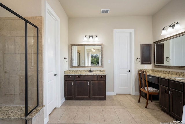 bathroom featuring vanity, tile patterned flooring, and walk in shower