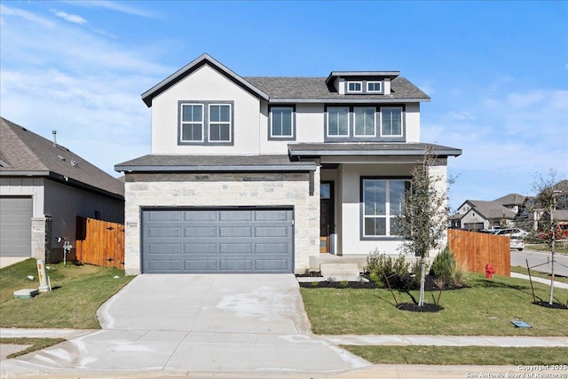 view of front of home with a front yard and a garage