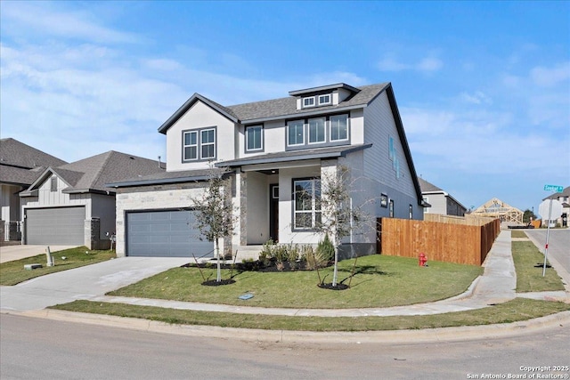 view of front of house featuring a front yard and a garage