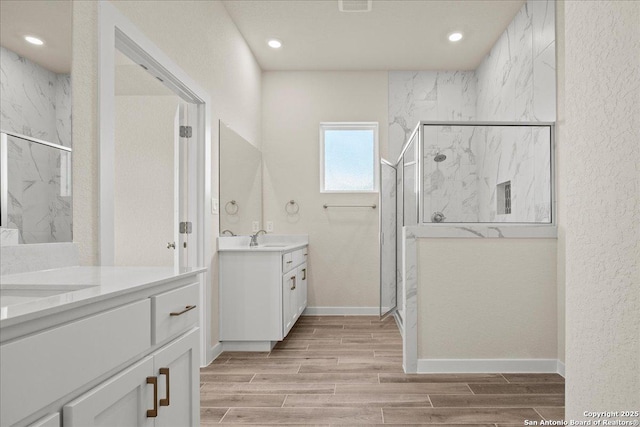 bathroom featuring vanity, walk in shower, and hardwood / wood-style floors