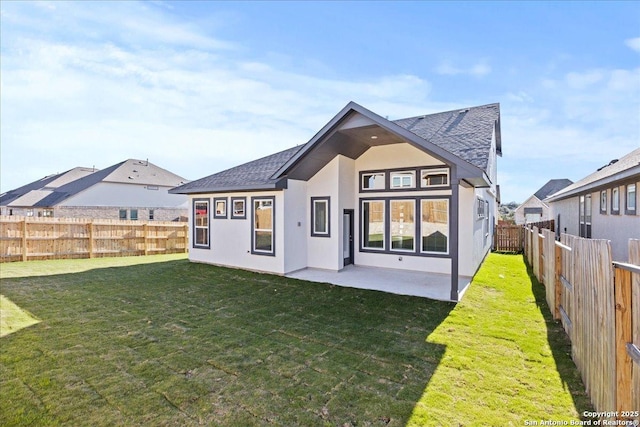 rear view of house featuring a patio and a yard