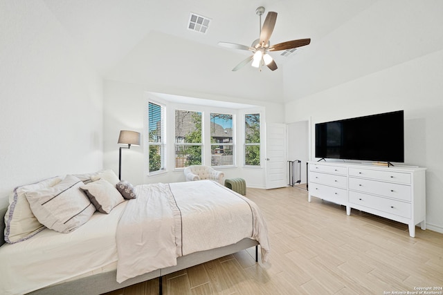 bedroom with vaulted ceiling, ceiling fan, and light hardwood / wood-style flooring