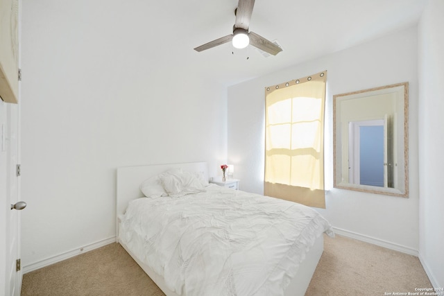 bedroom featuring light carpet and ceiling fan