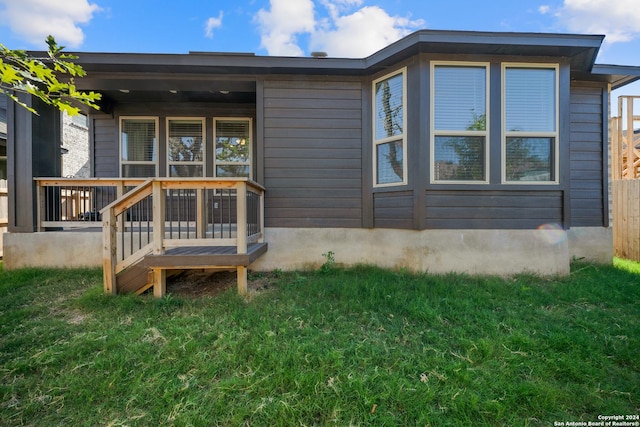 rear view of property featuring a yard