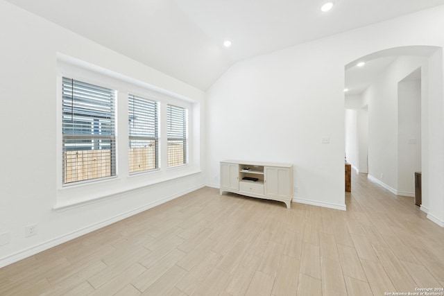 unfurnished room featuring vaulted ceiling