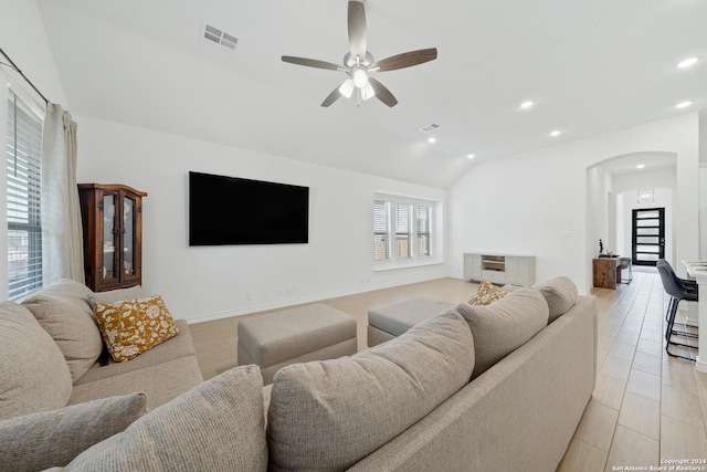 living room with ceiling fan and vaulted ceiling