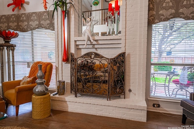 details featuring a brick fireplace and hardwood / wood-style flooring