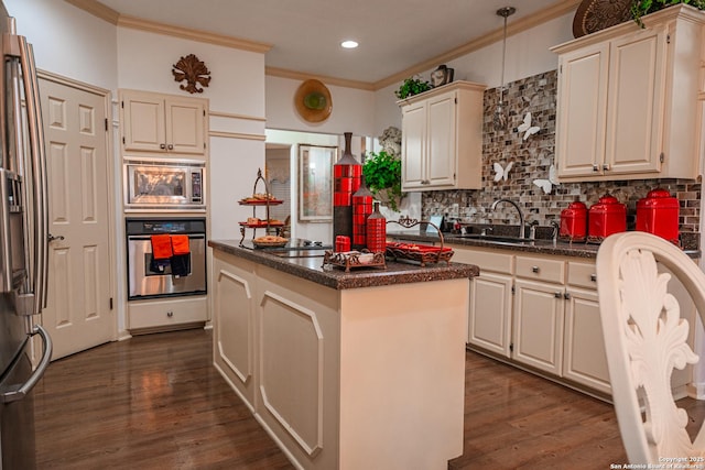 kitchen with sink, dark hardwood / wood-style flooring, a kitchen island, stainless steel appliances, and backsplash