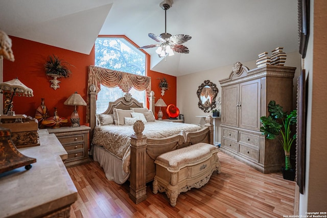 bedroom featuring ceiling fan, lofted ceiling, and light hardwood / wood-style flooring