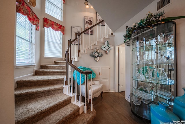 foyer entrance with hardwood / wood-style floors and a high ceiling