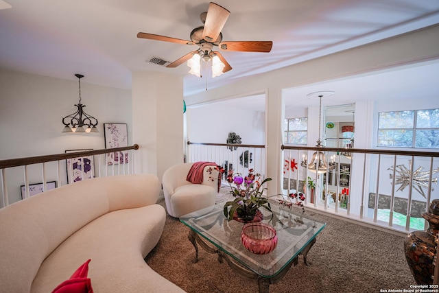 carpeted living room with a chandelier